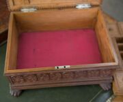 An Anglo-Indian workbox, superbly carved on all sides, with claw feet and compartmented lift out tray fitted with lids, early to mid 19th century, 18cm high, 32.5cm wide, 25.5cm deep - 10