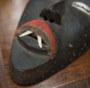 A tribal mask, carved wood, fabric and metal, African origin, 20th century, ​24cm high - 9