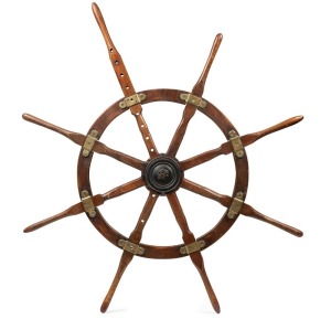 An antique ship's wheel with original cast iron cover plate and remains of mechanism, circa 1900, 148cm wide