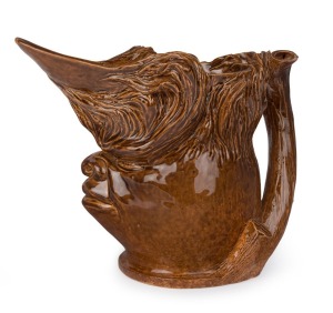 WILLIAM RICKETTS character jug, rare and early brown high gloss glaze, incised "W. M. Ricketts, Melbourne, 1934", 17.5cm high, 21cm wide