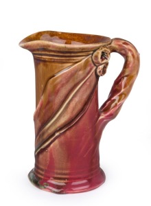 REMUED pink and brown glazed pottery jug with applied gumnuts, leaf and branch handle, incised "Remued", 13.5cm high