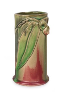 REMUED cylindrical pottery vase with applied gumnuts, leaf and branch, glazed in pink and green, incised "Remued", 16.5cm high