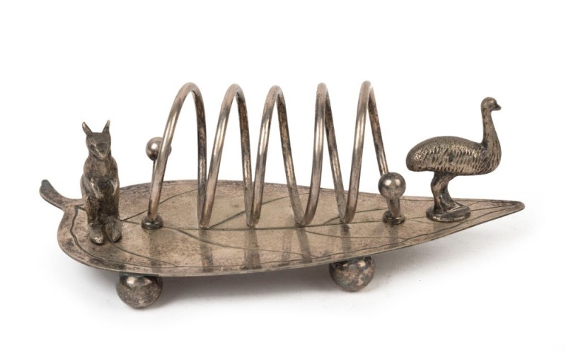 An Australian silver plated toast rack of gum leaf form adorned with a kangaroo and emu, late 19th early 20th century, ​​​​​​​18.5cm wide