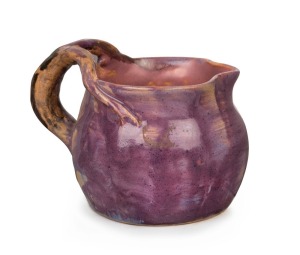 PEGGY WHITING mauve glazed pottery jug with windswept branch handle, incised "Peggy Whiting", 9.5cm high, 12cm wide