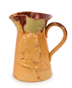PAMELA "Batman, Souvenir of Melbourne" pottery profile portrait jug with unusual caramel glaze with pink and green highlights, incised "Pamela, 1934", ​​​​​​​14cm high
