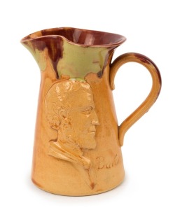 PAMELA "Batman, Souvenir of Melbourne" pottery profile portrait jug with unusual caramel glaze with pink and green highlights, incised "Pamela, 1934", 14cm high