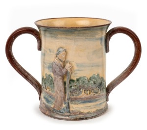 REMUED "Batman, Melbourne Centenary" rare pottery two-handled cup with applied figure in landscape, incised "This Is The Place For A Village", signed "Remued", 15cm high, 22cm wide