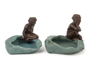 WILLIAM RICKETTS pair of unusual pottery dishes with kneeling Aboriginal figures, rare blue and brown colourway, the female example incised "W. M. Ricketts, Melbourne, 1935", ​​​​​​​8cm high, 10cm wide