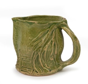 MERRIC BOYD green glazed pottery jug with windswept branch handle and sgraffito farm landscape decoration, incised "Merric Boyd, Gumtree", ​​​​​​​12cm high, 15cm wide