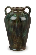 "DISABLED SOLDIER'S POTTERY" vase with two handles and green glaze, Monogram cross mark to base, 21cm high