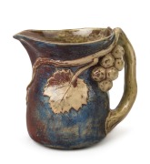 MERRIC BOYD pottery jug with applied grapes, leaves and branch handle, incised "Merric Boyd (M), 1929", 16cm high, 18cm high