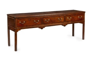 A fine George III dresser base, oak with mahogany cross-banding, three drawers with brass swing handles and original brass escutcheons to keyholes, plus fluted decoration and square form legs, 18th century, 81cm high, 202cm wide, 54cm deep