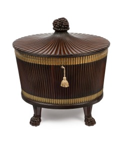 A stunning antique Irish George III mahogany standing cellarette of oval form with fine reeded decoration and tapered fluted cover adorned with carved grape bunch finial, original lock, hinge and lead liner with brass trim all resting on four carved lion paw feet, circa 1770. An exceptional and rare example. 75cm high, 71cm wide, 53cm deep
