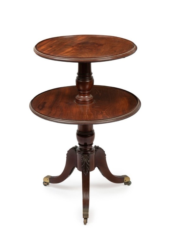 A George III English mahogany two tier circular dumbwaiter, finely crafted with carved and reeded scrolling acanthus legs on urn shaped turned column, original and attractive castors, circa 1815, 83cm high, 56cm diameter