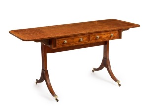 An antique English Regency sofa table, satinwood with cross-banded border and marquetry string inlay with fine out-swept legs and original brass castors, two drawers with original brass knobs and escutcheons, early 19th century, 73cm high, 91cm (extends to 151cm) wide, 60cm deep