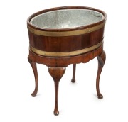 A Georgian English brass bound mahogany planter stand of oval form on cabriole legs terminating in small circular pad foot, 18th/19th century, 70cm high, 63cm wide, 47cm deep