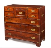 An antique English mahogany military campaign chest with fitted secretaire central drawers, original brass bindings to edges and corners, superb detailing with cockbeading and cross-banded edges, circa 1830. One of the finest examples seen in our rooms. 1 - 2