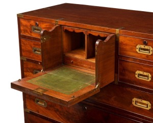 An antique English mahogany military campaign chest with fitted secretaire central drawers, original brass bindings to edges and corners, superb detailing with cockbeading and cross-banded edges, circa 1830. One of the finest examples seen in our rooms. 102.5cm high, 110cm wide, 51cm deep