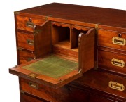 An antique English mahogany military campaign chest with fitted secretaire central drawers, original brass bindings to edges and corners, superb detailing with cockbeading and cross-banded edges, circa 1830. One of the finest examples seen in our rooms. 1