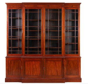 An antique English provincial breakfront mahogany four door astragal glazed bookcase with blind panelled base, circa 1800, 215cm high, 207cm wide, 45cm deep