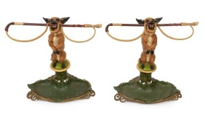 A pair of antique English figural umbrella stands, cast iron with polychrome painted finish in the form of a dog holding a whip, mid 19th century, 60cm high