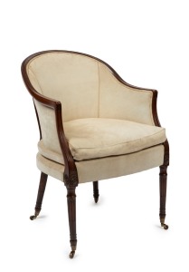 An antique English library armchair, finely carved mahogany frame with original brass castors and later upholstery, early 19th century, 88cm high, 60cm across the arms