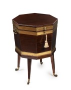 A Georgian brass bound mahogany cellarette of octagonal form with tapering square form legs and brass castors, original zinc lined interior with bottle bezel, circa 1800 65cm high, 46cm wide, 46cm deep