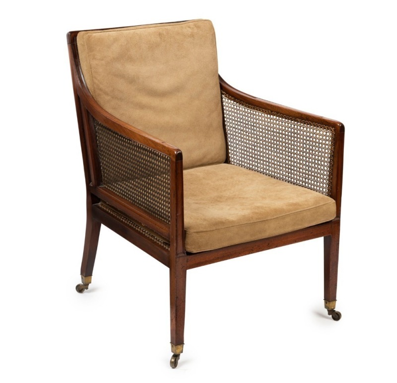 An antique English mahogany armchair with original rattan caning to the sides, square tapering front legs, splay rear legs and original brass castors, 19th century, 87cm high, 62cm across the arms