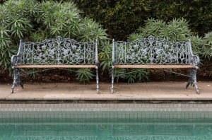 A pair of antique English cast iron garden seats, 19th century, 86cm high, 130cm wide