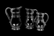 A graduated set of three antique English glass ale jugs, circa 1820, the largest 27.5cm high