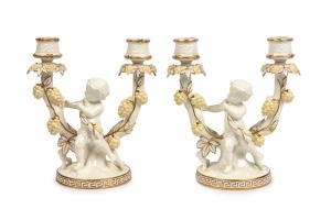 MOORE BROTHERS pair of two branch figural candelabras with putti figures and grapes, 19th century,| stamped and impressed "Moore", 21cm high, 18cm wide