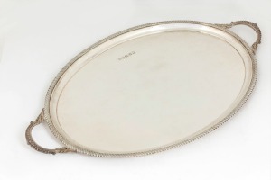 Queen Elizabeth II jubilee English sterling silver oval serving tray with heavy gadrooned mounted border and loop handles, made in the Georgian style, stamped "B.E.S. Co.", made in Sheffield, circa 1977, 62.5cm across the handles, 2370 grams