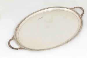 Queen Elizabeth II jubilee English sterling silver oval serving tray with heavy gadrooned mounted border and loop handles, made in the Georgian style, stamped "B.E.S. Co.", made in Sheffield, circa 1977, 62.5cm across the handles, 2370 grams