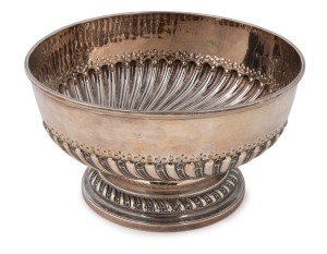 George III English sterling silver punch bowl of circular form with raised foot base and heavy gadrooned decoration to the centre. Made by Henry Greenway of London, circa 1777, 15cm high, 27cm diameter, 1318 grams  