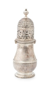Queen Anne sterling silver baluster shaped sugar castor of impressive proportions. Recessed circular raised foot base with fluted decoration to the lower baluster shaped body and raised rim above. Original cover (hallmarked), mounted on a gadrooned base with fine piercing and engraving depicting a lattice to the upper part and floral decoration to the lower. An attractive turned circular finial to top. A fine and early example. Most likely made by Charles Adam of London, circa 1710,