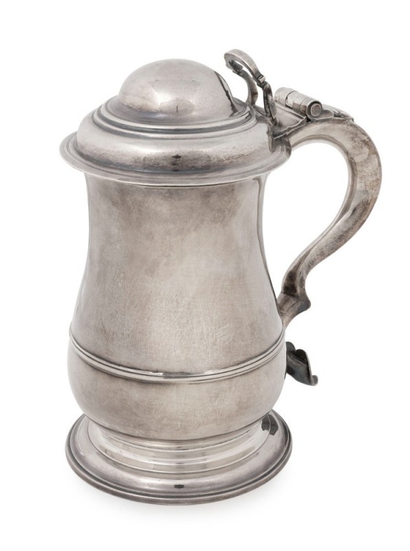 George II English sterling silver covered tankard with circular moulded foot base to a well proportioned body having single reeded rim raised to the lower part. An attractive loop handle with heart shaped terminal to base. Original hinge with looped thumb