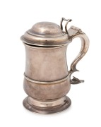 George II English sterling silver lidded baluster shaped tankard with circular raised foot, single band of raised reeding to the lower body, a hinged and domed lid with open-cast thumbpiece. Note the very attractive engraved elephant armorial crest. made