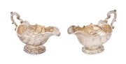 GEORGE III fine quality pair of cast sterling silver Rococo style sauce boats with scallop-footed bases, generous shell-shaped bodies and double scroll handles. Made by Richard Sibley of London, circa 1824 & 1825, 14.5cm high, 21.5cm wide, 1170 grams tota