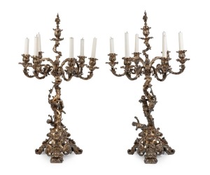 ELKINGTON & Co. stunning pair of silver plated seven branch table candelabra in the high Rococo manner with dancing Putti figures, grapevine adornments and stag head hand engraved armorial crests. London, circa 1850s, an imposing 86cm high