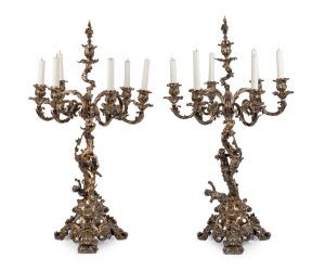 ELKINGTON & Co. stunning pair of silver plated seven branch table candelabra in the high Rococo manner with dancing Putti figures, grapevine adornments and stag head hand engraved armorial crests. London, circa 1850s, an imposing 86cm high