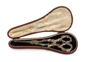 An antique pair of sterling silver grape scissors with delicate grapevine decoration to the handles. Original Garrards of Regent Street plush lined case. Made by Francis Higgins II of London, circa 1863, 19cm long, 144 grams.
