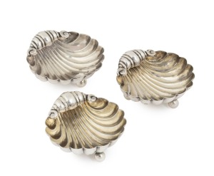Three antique English sterling silver table salts in the form of shells; each raised on three ball feet. Various makers including William Henry Leather of Birmingham, late 19th century