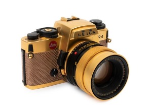 LEITZ: Leica R4 Gold [#1651925] pale brown snakeskin body cover and C157 number plate affixed on rear of body, 1984, with a gold and black special edition Summilux-R f4 50mm lens [#3295897]. Original felt-lined presentation timber case, box, paperwork and