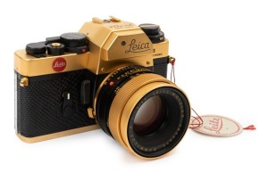 LEITZ: Leica Model R3 Gold [#1523989] black lizard skin covering, issued in 1979 to commemorate The 100th Anniversary of Oskar Barnack's birth with a facsimile of his signature and the dates engraved on top of the prism housing. Fitted with matching gold 