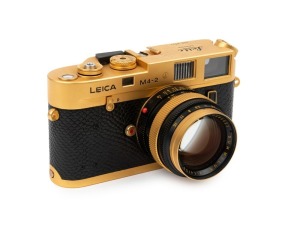 LEITZ Canada: Leica M4-2 Gold Plated Special Edition [#1528598], 1979, limited edition of 1000 to commemorate the birth of Oskar Barnack, with black and gold plate Summilux f4 50mm lens [#2980853]. The camera numbered 100-0573 on top plate. Original box i