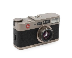 LEITZ: Leica Model CM 35mm point-and-shoot camera, 2004, [#2952002] with fixed Summarit f2.4 40mm lens and Leica brown leather carry case with strap.