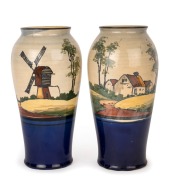 REG HAWKINS, PREMIER POTTERY PRESTON (P.P.P.) pair of pottery mantle vases with windmill and cottage scene. Rare blue glazed bases, signed "Reg Hawkins, P.P.P.", 26.5cm high