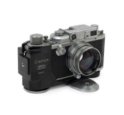 Canon 'Canon Camera Company Ltd'&nbsp; Model 11B&nbsp;rangefinder camera [#38508], 1950, with Serenar&nbsp;50mm f1.9 lens [#28832]; the bottom plate engraved "Made in Occupied Japan". Displayed in a Canon Camera Holder (Type 2) with metal tripod mount.