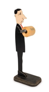 PAUL KEATING toilet roll holder with MALCOLM FRASER toilet paper. carved and painted wood. ​​​​​​​An irreverent Australian political novelty item poking fun at Treasurer/Prime Minister Paul Keating. 77cm high