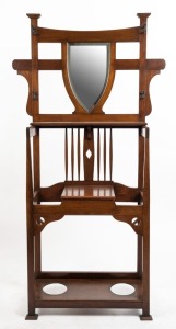 An Australian Arts & Crafts Queensland maple hallstand with shield shaped mirror, early 20th century, 191cm high, 100cm wide, 30cm deep